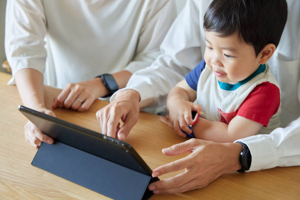 istock Children and parents play with computers and smartwatches 2158989412