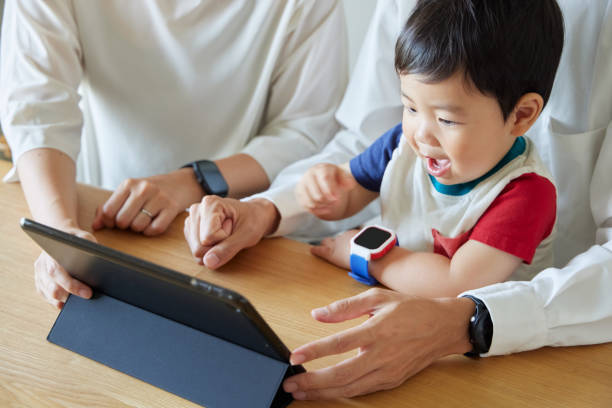 istock Children and parents play with computers and smartwatches 2158989417