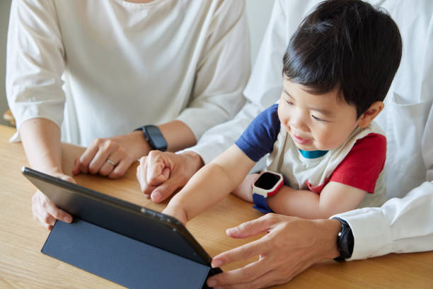 istock Children and parents play with computers and smartwatches 2158989419