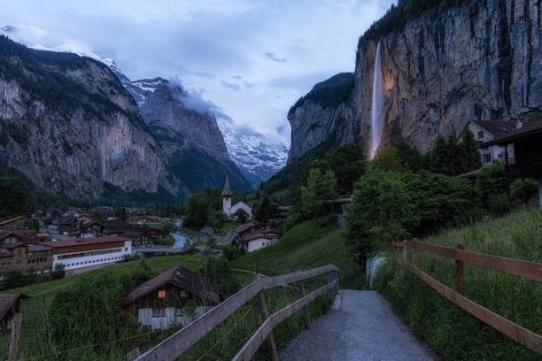 The view of Lauterbrunnen and village town and Staubbach waterfall taken in the morning. Famous tourist attraction in Switzerland
