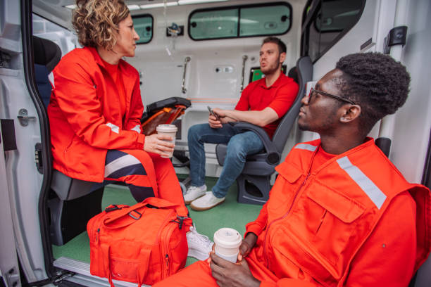 istock Paramedics team taking break inside ambulance holding coffee cups 2158991606