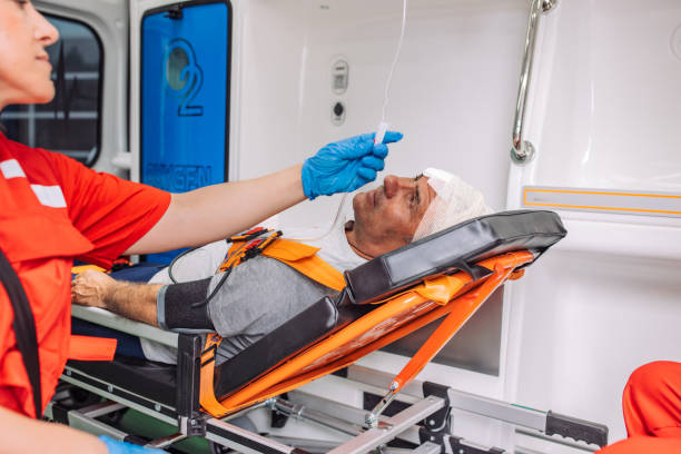 istock Paramedic assisting injured patient inside ambulance 2158992959