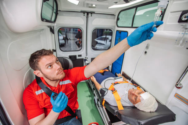 istock Paramedic adjusting iv drip while transporting injured patient in ambulance 2158993613
