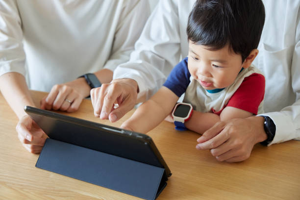 istock Children and parents play with computers and smartwatches 2158993772