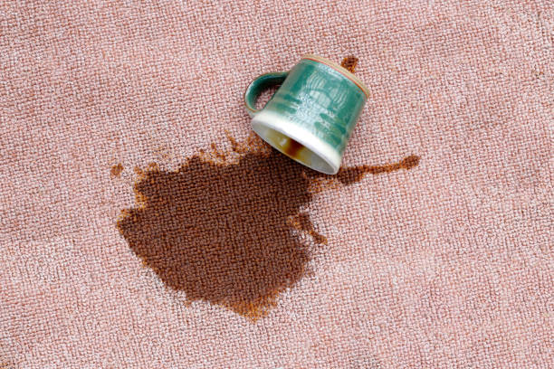 istock Coffee spilled from green cup on the carpet 2158994037