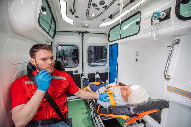 istock Paramedic talking on radio while transporting patient in ambulance 2158994070