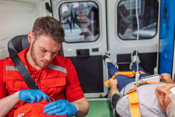 istock Paramedic preparing first aid equipment with patient in ambulance 2158994896