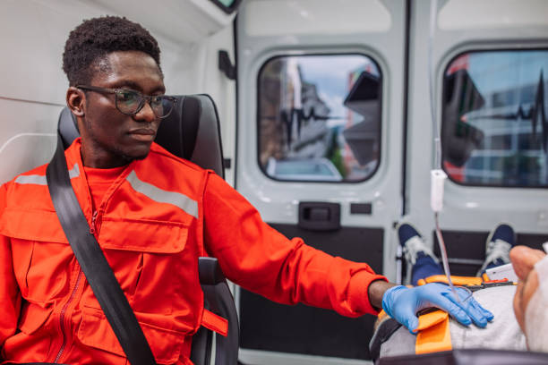 istock Focused paramedic assisting injured patient in ambulance 2158995031