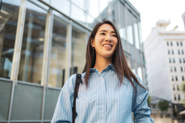 istock Happy Asian woman commuting in urban setting. 2158996100