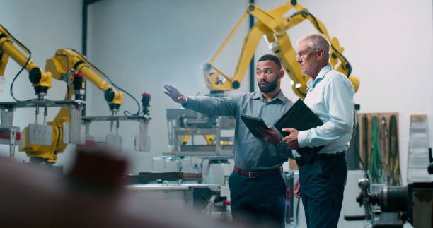 istock Robotics, planning and engineer collaboration with industrial teamwork and men in warehouse. Factory, engineering and futuristic work of manufacturing management with discussion for cnc automation 2158997912