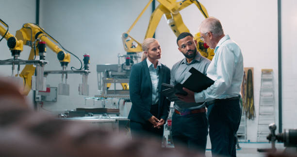 istock Robotics, staff and engineer collaboration with industrial teamwork and working in warehouse. Factory, engineering and futuristic work of manufacturing management with discussion for cnc automation 2158997919