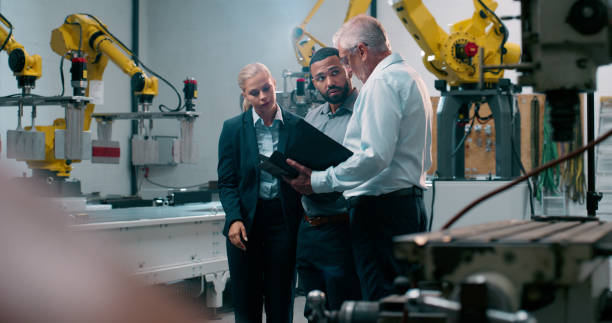 istock Robotics, staff tablet and engineer management with industrial collaboration and working in warehouse. Factory, engineering and production people of manufacturing team with talk for cnc automation 2158997926