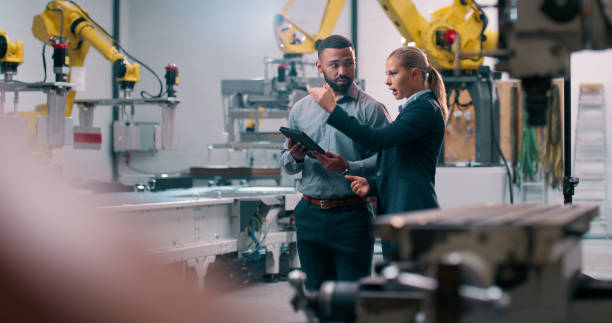istock Robotics, staff and engineer planning with industrial teamwork and conversation in warehouse. Factory, engineering and futuristic work of manufacturing management with discussion for cnc automation 2158997933