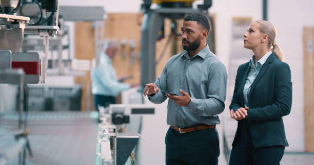 istock Engineering, supervisor or business people with tablet or robotics for production check or innovation. Teamwork, manufacturing or process automation consultant with technology, machine or inspection 2158997959