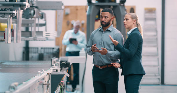 istock Manufacturing, teamwork or business people with tablet or robotics for production check or innovation. Supervisor, engineering or process automation consultant with technology, machine or inspection 2158997961