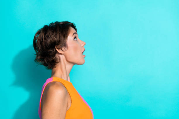 istock Photo of impressed funky lady dressed colorful top looking up empty space isolated turquoise color background 2158998021