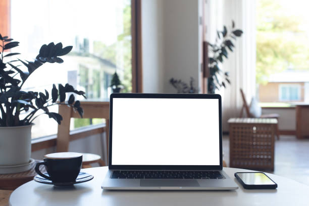 istock Mockup, laptop blank screen on wood table with coffee cafe background, template for your text advertisement, front view 2158998128