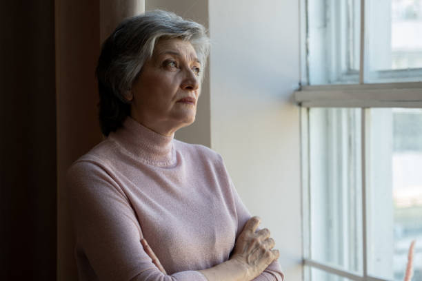 istock Senior Woman Contemplating By Window During Daytime 2159000968