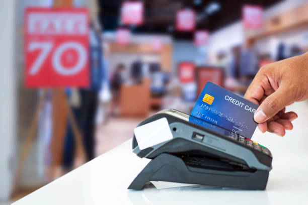 istock Hand using credit card at sale terminal 2159003070