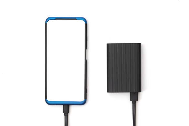 istock Smartphone and external battery for charging devices isolated on white. Top view 2159003406