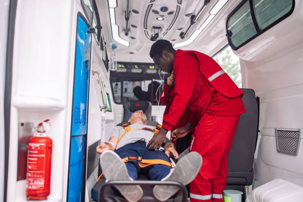istock Paramedic securing patient with seatbelt inside ambulance 2159004049