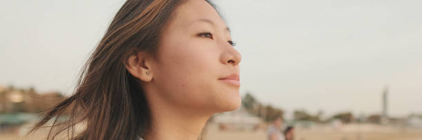 istock Young beautiful woman walking on the beach, panorama 2159004342