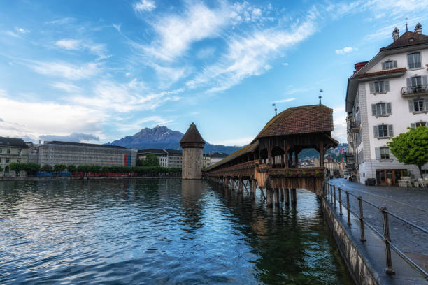 the view of chapel bridge over the Reuss river at sunrise. Famous landmark in Lucerne, Switzerland. Taken on May 27 2024
