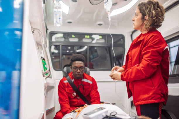 istock Paramedics assisting injured patient inside ambulance 2159004673