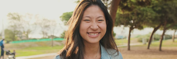 istock Close up, young woman posing at camera while standing in park, Looking at camera, panorama 2159005028
