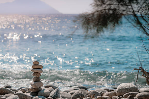 Stones balance on beach, sunset shot with blurry background