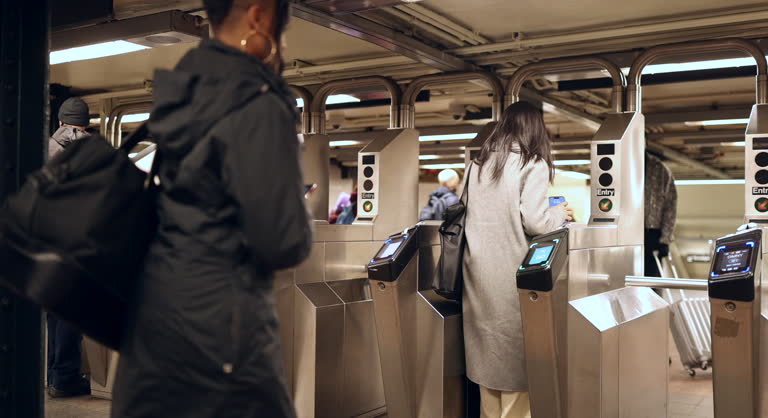 Urban Commuters Using Subway Turnstiles in Evening