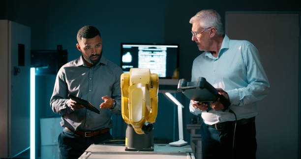 istock Engineering, production and business people with automation robotics for technology innovation. Research, information and machine programmers working with industrial system for database manufacturing 2159009434
