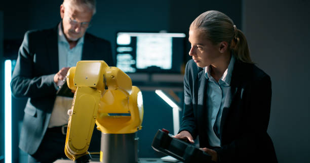 istock Engineering, innovation and business people with automation robotics for futuristic technology. Research, information and machine programmers working with industrial system for database production. 2159009440