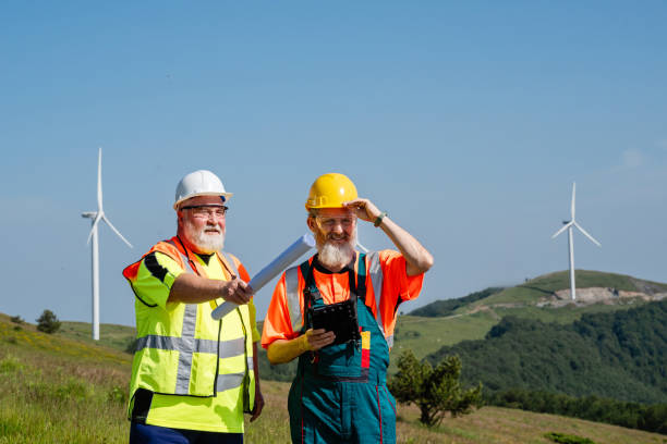 istock Two engineers working at an alternative renewable wind energy farm 2159010051