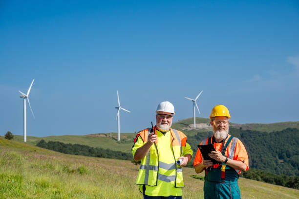 istock Engineers reporting a problem  in a wind turbine farm Walkie-talkie 2159010072