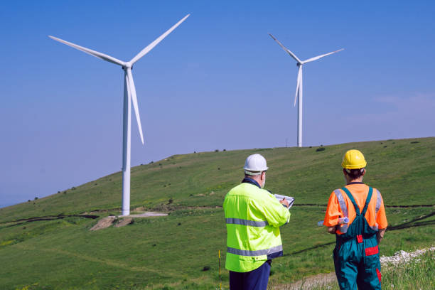 istock Two engineers working at an alternative renewable wind energy farm 2159010122