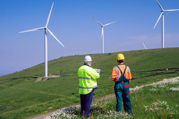 istock Two engineers working at an alternative renewable wind energy farm 2159010131
