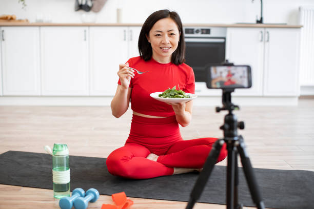 istock Woman recording healthy eating vlog in kitchen 2159010162