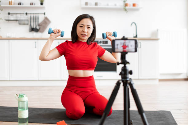 istock Woman exercising with dumbbells during home workout session 2159010220