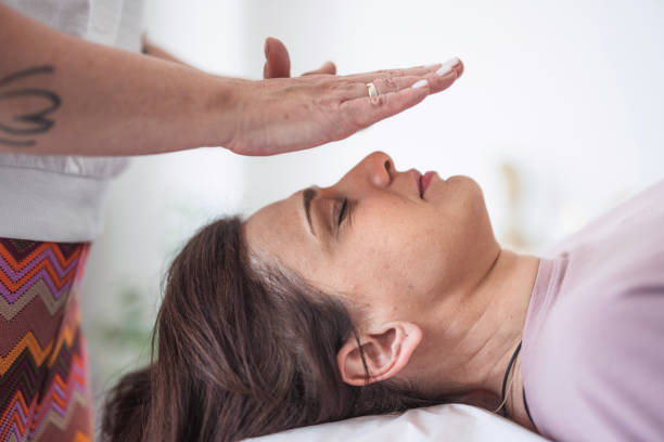 istock Woman having reiki healing treatment 2159013154
