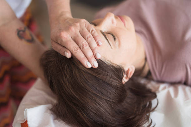 istock Woman using reiki therapy to help with headache 2159013262