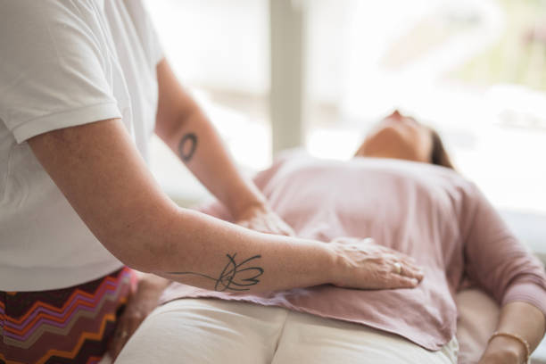 Patient undergoing reiki treatment to improve quality of life