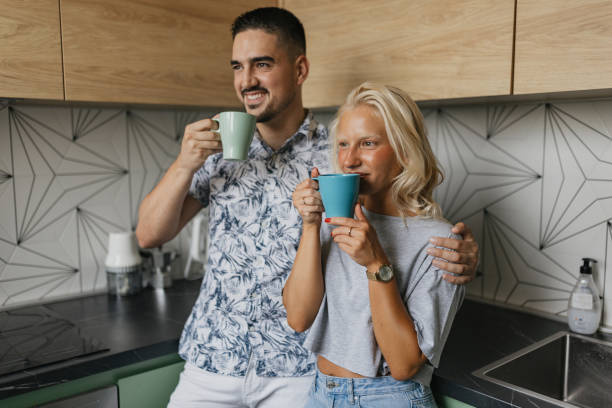 istock Friends sharing morning coffee in stylish kitchen. 2159013988