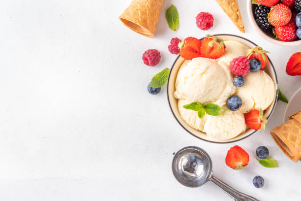 istock White ice cream bowl with vanilla gelato and fresh berries 2159014267