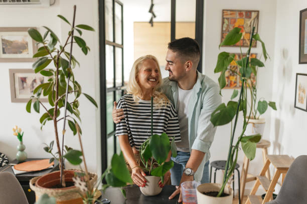 istock Couple sharing a joyful moment with indoor plants. 2159014687