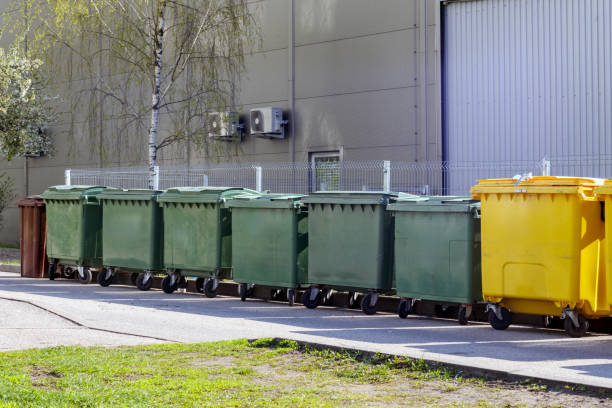 istock .garbage containers on the wall of a gray building 2159017181
