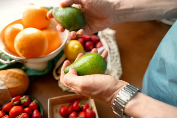 istock Senior man unpacking groceries at kitchen, reusable shopping bag with fruit and vegetables, environment conservation and sustainability concept 2159018280