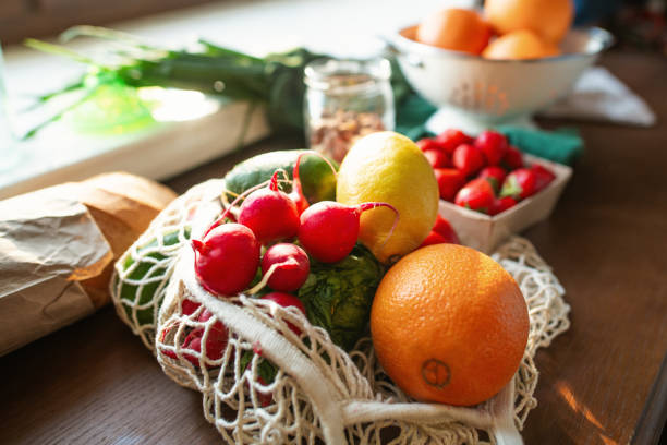 istock Groceries at kitchen, reusable shopping bag with fruit and vegetables, environment conservation and sustainability concept 2159018484