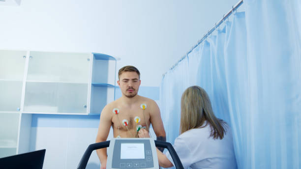 istock Medical Professional Preparing Patient for ECG Test 2159019100