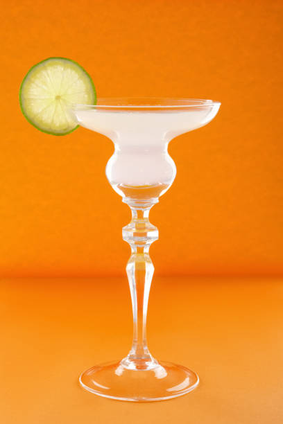 istock Gin tonic cocktail on orange background 2159019483